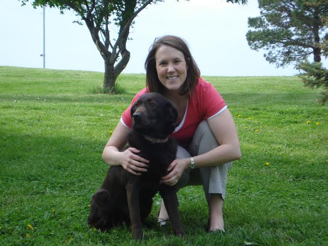 Dr. Michelle Beck DVM with her Chocolate Labrador Dog